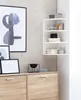 A corner shelf unit with decorative items and a cabinet below, set against a textured wall. Anteprima dell’immagine prodotto