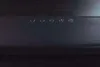 A close-up view of the top surface of a black soundbar, showing several control buttons. Produktbild-Vorschau