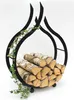 A black metal firewood rack shaped like flames, filled with logs and decorated with a green ivy vine, set against a white background. Produktbild-Vorschau