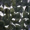 A close-up view of a green artificial hedge fence attached to a wire mesh. Náhled obrázku produktu