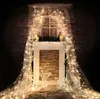 A festive, dimly lit scene featuring a decorated fireplace with Christmas lights and decorative reindeer. Produktbild-Vorschau
