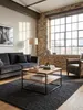 Industrieller Couchtisch aus Akazie Massivholz 60x60 cm in einem modernen Wohnzimmer mit großem Sofa und einem weichen Teppich, der eine warme Atmosphäre schafft._#sku_BARWL6.363# Produktbild-Vorschau
