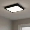 A square black ceiling light with a white illuminated diffuser is mounted on a light gray ceiling. Náhľad obrázku produktu