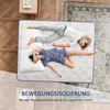 A couple sleeping on a mattress, with text overlay promoting motion isolation. Produktbild-Vorschau