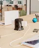 A power strip tower with multiple outlets and USB ports is shown on a wooden desk, connected to laptops and a phone. Produktbild-Vorschau