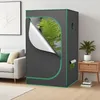 A grow tent is set up in a living room next to a sofa and a side table with a plant. Náhled obrázku produktu
