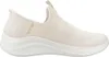 A side view of a single beige Skechers slip-on sneaker against a white background. Voir les images du produit