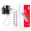 A UNITEK USB hub, its power adapter, and its packaging are laid out on a white background. Voir les images du produit