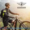 A man riding a mountain bike on a trail with a scenic mountain background. Produktbild-Vorschau