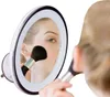 A woman is applying makeup using a mirror with LED lights. Produktbild-Vorschau