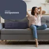 A woman relaxing on a sofa with a bolster pillow. Podgląd zdjęcia produktu