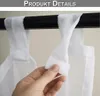 A hand is shown adjusting a white fabric curtain loop attached to a black curtain rod. Voir les images du produit