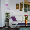A living room scene with a white sofa, a glass coffee table, and a floor lamp. Produktbild-Vorschau