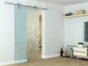 A glass sliding door with a geometric pattern is shown in a room setting. Náhľad obrázku produktu