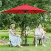 A couple and a dog enjoying a picnic under a red umbrella in a garden. Produktbild-Vorschau