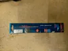 A Bosch EXPERT saw blade in its packaging, lying on a wooden surface. Voir les images du produit