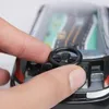 Kinderhand drückt auf das schwarze Lenkrad eines schwarzen Spielzeugautos mit Straßengrafik im Inneren Produktbild-Vorschau