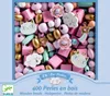 A close-up, overhead view of a collection of colorful wooden beads and charms, arranged in a box. Anteprima dell’immagine prodotto