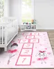A child's bedroom with a crib and a hopscotch rug. Podgląd zdjęcia produktu
