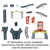 A collection of toy train tracks and accessories, including two toy trains, a finish line arch, various track pieces, and a multi-level play structure. Náhľad obrázku produktu