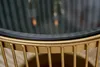 Close-up of the edge of a round coffee table, showing the gold metal frame and the black glass top. Produktbild-Vorschau