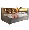 A bed with a bookshelf headboard and integrated lighting. Produktbild-Vorschau