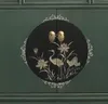A close-up view of a green cabinet with a circular decorative inlay featuring birds, lotus flowers, and a crane. Produktbild-Vorschau