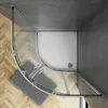 A top-down view of a modern corner shower enclosure with a curved glass door, set against a tiled wall and wooden floor. Produktbild-Vorschau