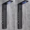 Two views of a modern black shower panel system with a rainfall showerhead, handheld shower, and body jets, mounted on a tiled wall. Náhled obrázku produktu