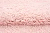 A close-up, textured view of a pink shaggy rug. Produktbild-Vorschau