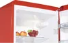 Close-up view inside a red refrigerator, showing a shelf with apples and raspberries. Produktbild-Vorschau