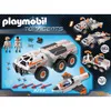 The image shows the packaging for a Playmobil Top Agents Battle Truck toy set, displaying the main truck, a jet, and accessories. Produktbild-Vorschau