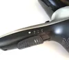A close-up view of the controls and handle of a black and silver hairdryer. Produktbild-Vorschau
