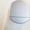 A silver-colored speaker is shown against a white and light gray background, casting a shadow. Produktbild-Vorschau