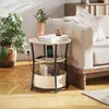 A bedside table with a phone charging on it, next to a sofa and a plant. Produktbild-Vorschau