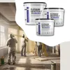 Construction workers applying sealant to walls in a room under renovation. Produktbild-Vorschau