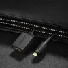 A black Ugreen Micro-HDMI to HDMI cable adapter is shown on a black textured surface, possibly a bag. Produktbild-Vorschau