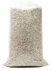 A clear, professional studio shot of a large, transparent plastic bag filled with light-colored granular material, likely perlite, against a plain white background. Voir les images du produit