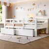 A white wooden children's bed with two drawers underneath, set up in a child's bedroom. Anteprima dell’immagine prodotto