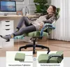A woman relaxing in a green gaming chair with her feet up on an extended footrest, in a home office setting. Náhľad obrázku produktu
