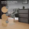 A close-up view of a chest of drawers with a chair and flooring, showcasing wood texture details. Produktbild-Vorschau