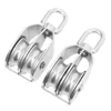 Two stainless steel double pulleys are shown against a white background. Voir les images du produit