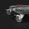 A close-up, low-angle view of the wheels and lower part of a black transport platform. Náhled obrázku produktu
