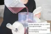 Eine Person gießt rote Flüssigkeit in den transparenten Behälter der Unold 2in1-Slush- und Softeisma Produktbild-Vorschau