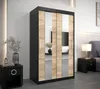 A bedroom scene featuring a wardrobe, nightstand, and bed. Produktbild-Vorschau