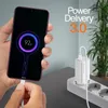 A person is holding a smartphone that is charging, with a charger plugged into a power strip in the background. Anteprima dell’immagine prodotto