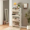 A white shoe cabinet with multiple flip-out drawers filled with shoes, placed in a hallway next to a mirror and a plant. Anteprima dell’immagine prodotto