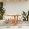 A wooden folding table and chairs set on a patio with plants. Podgląd zdjęcia produktu