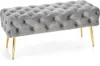 A tufted upholstered bench with gold legs on a white background. Produktbild-Vorschau