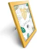 A yellow picture frame with a tropical leaf pattern insert, displayed on a white background. Produktbild-Vorschau